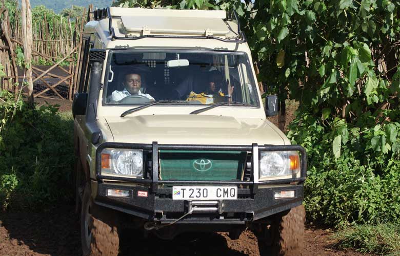 Driving safarivehicle with a private safari group inside 