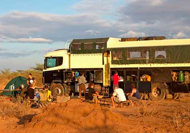 Camp of safari group in front of their bus